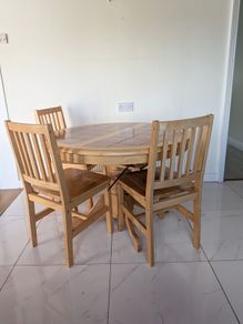 solid pine pedestal dining table with 4 matching four slatted wooden chairs.