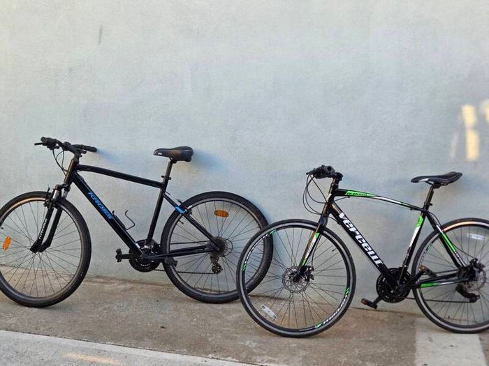 Two bikes one mountain one is a type of racing mountain bike