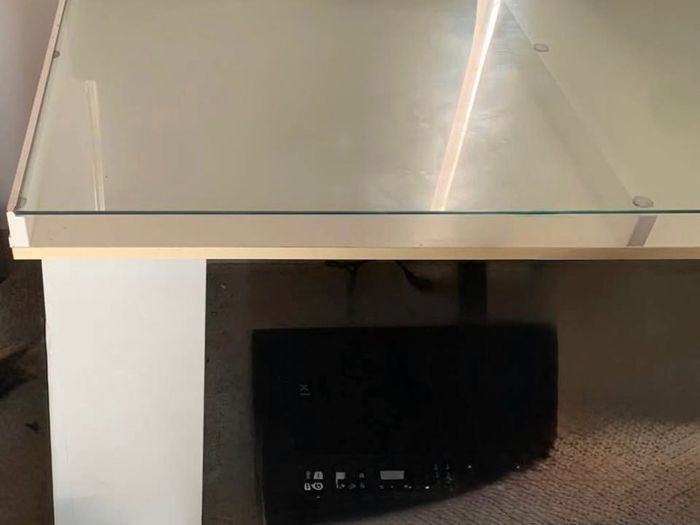 Study/ Office table Used but in great condition This is a modern minimalist table with a sleek white finish and a glass top