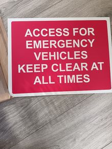 Emergency vehicle access sign board for parking area.
