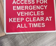 Emergency vehicle access sign board for parking area.
