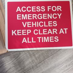 Emergency vehicle access sign board for parking area.