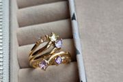 The ring has a unique stacked design with several bands and beautiful pastel/coloured stones, including purple, green and champagne tones. The hallmark has worn away over time, but the ring was tested today and confirmed as genuine 14K gold weight 3.95g.
