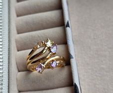 The ring has a unique stacked design with several bands and beautiful pastel/coloured stones, including purple, green and champagne tones. The hallmark has worn away over time, but the ring was tested today and confirmed as genuine 14K gold weight 3.95g.