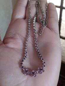 Beautiful necklace in silver tone with pink crystals in the form of flowers.