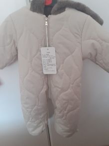 New unisex snow suit beigh with brown fur lining .Never worn size 0-3 months