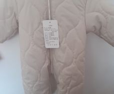 New unisex snow suit beigh with brown fur lining .Never worn size 0-3 months