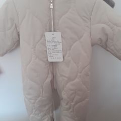 New unisex snow suit beigh with brown fur lining .Never worn size 0-3 months