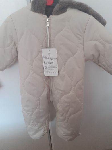 New unisex snow suit beigh with brown fur lining .Never worn size 0-3 months