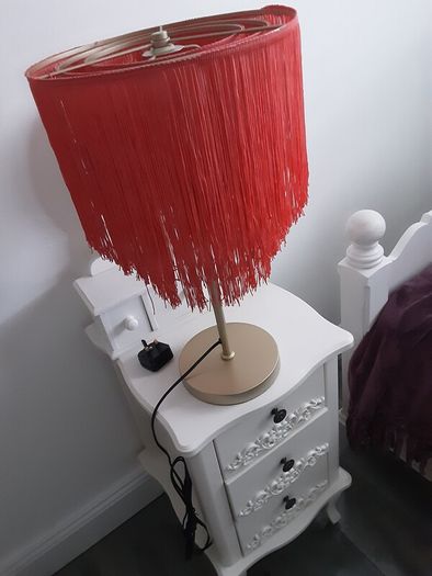 Orange fringed lamp on bass base