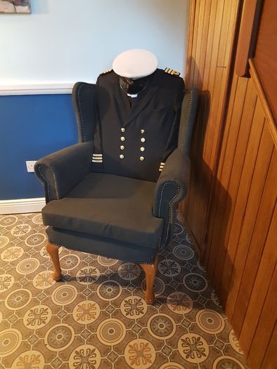 Queen Anne wingback chair / Quirky Ships Commander's uniform.
