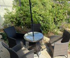 garden table four chairs and parasol