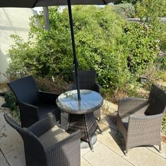 garden table four chairs and parasol
