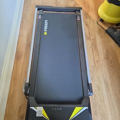 Folding Treadmill with remote control and manually adjustable incline.