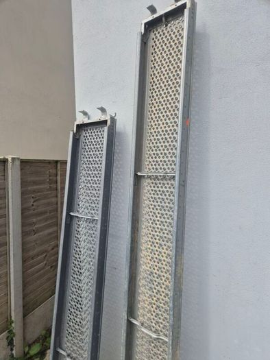 Two galvanised steel scaffolding planks