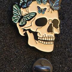 Skull/butterfly , pin back badge.