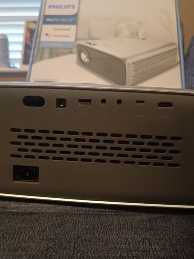 philips neopix ultra 2tv+ home projector and height adjustable stand, built in speakers and android TV with play store stand comes with power point bracket on it as seen in pictures also remote and phone holder
