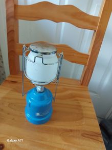 The LUMOGAZ T 206 camping gaz is a vintage handheld lantern that runs on butane/propane gas, making it a reliable lighting source for camping trips or emergencies.