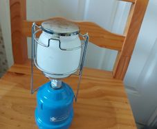 The LUMOGAZ T 206 camping gaz is a vintage handheld lantern that runs on butane/propane gas, making it a reliable lighting source for camping trips or emergencies.