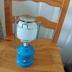 The LUMOGAZ T 206 camping gaz is a vintage handheld lantern that runs on butane/propane gas, making it a reliable lighting source for camping trips or emergencies.