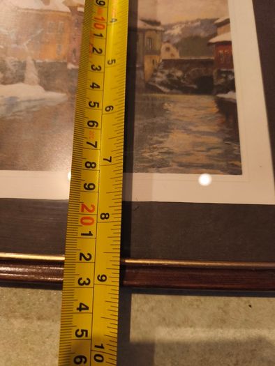 Framed print of  Snow-Covered Buildings by a River by Fritz Thaulow (1847 - 1906).