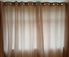Textured light brown swirl patterned eyelet curtains from The Glenmount Collection made of polyester  size h 230cm, w 220cm (each)
