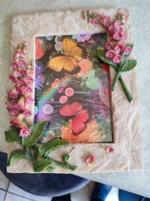BUTTERFLIES picture framed in stone finish frame edged with flowers.