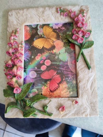 BUTTERFLIES picture framed in stone finish frame edged with flowers.