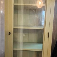 Sage green tall storage cabinet