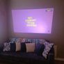 philips neopix ultra 2tv+ home projector and height adjustable stand, built in speakers and android TV with play store stand comes with power point bracket on it as seen in pictures also remote and phone holder Image 3