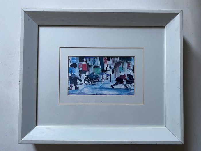 a pair of prints framed and glazed in a white frame