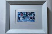 a pair of prints framed and glazed in a white frame