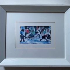 a pair of prints framed and glazed in a white frame