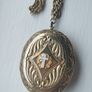 A large medallion featuring religious symbols, suspended from a long chain. Image 2
