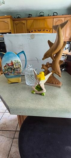 Is 4 items 1-  vintage Lancaster Sandland English Ware ceramic pitcher featuring a transferware scene of a tavern or inn. in good overall condition 20.00 euro, Tipperary crystal jam / honey pot 23.00 euro, Marine Dolphin Statue, Solid Wood Carved 35.00 eu