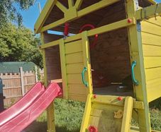 Playhouse with look out tower, swings, slide, picnic table