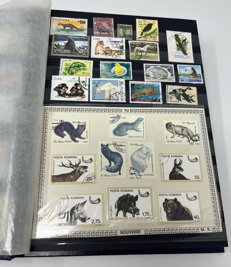 Ace Black 32 page/ 16 leaf Stamp Album with over 900 stamps. Thematic of Animals, Plants, Classic Cars, Space, Trains, Sport & Disney noted.