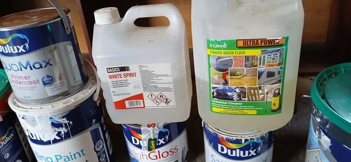 a selection of paint and a paint roller and some good paint brushes
