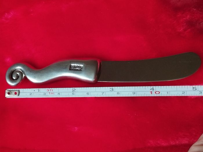 A collectible knife made of polished pewter with a stainless steel blade from Carrol Boyes.