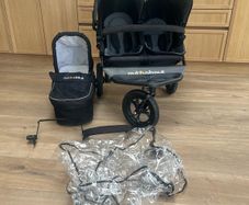 out n about double buggy with newborn section and rain cover