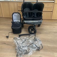out n about double buggy with newborn section and rain cover