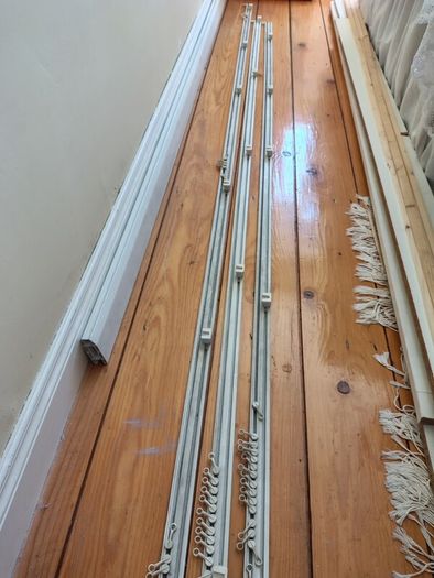 Three white plastic curtain rails