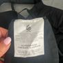 Black Ergobaby Omni 360 Baby Carrier featuring adjustable waist snaps on the front Image 3