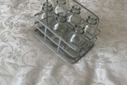 6 mini glass bottles in holder