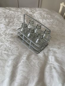 6 mini glass bottles in holder