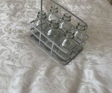 6 mini glass bottles in holder