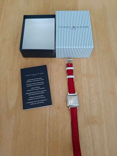 Tommy Hilfiger watch features a distinctive rectangular stainless steel case and a reversible red, white, and blue leather strap
