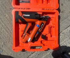 Paslode PPNXi cordless gas nailer in original orange carry case.
