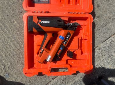 Paslode PPNXi cordless gas nailer in original orange carry case.
