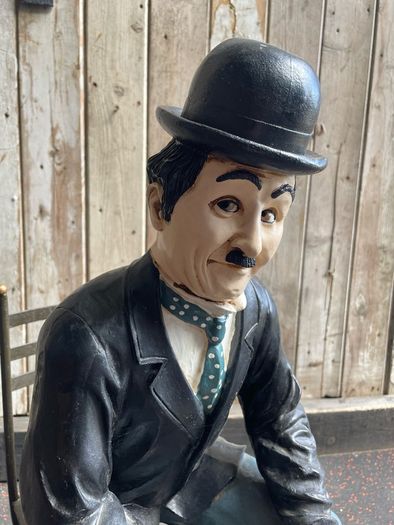 Charlie Chaplin resin sculpture figurine in metal chair